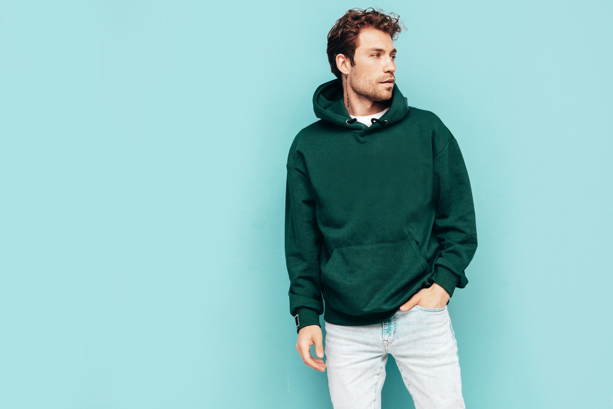 handsome-confident-hipster-modelsexy-unshaven-man-dressed-summer-stylish-green-hoodie-jeans-clothes-fashion-male-with-curly-hairstyle-posing-studio-isolated-blue (1)